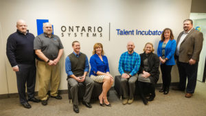 Attendees from Ontario Systems include (from left to right) -- Jeff Spires, Director, Software Engineering; Troy Sanders, Facilities Specialist; Stephen Hunter, Sr. Technical Project Manager; Darla Brown, Director, Talent Acquisition; Bob Mattax, Manager, Software Engineering; Jenny Johnson, HR Generalist; Joani Scott, Director, Corporate Services; and Jason Harrington, President. Photo by: Ontario Systems