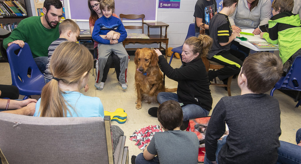 Jackson the therapy dog and handler Megan Floyd visit the after school program at Ross Community Center. Photo by: Mike Rhodes
