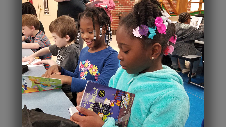 Damiyah Watkins, Tionna Canady and Jacob Johnson, South View Elementary students, could not wait to begin reading their Summer Book Give Away. Photo provided by United Way