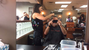 Holly Ling cuts the hair of another satisfied customer. Photo by: John Carlson