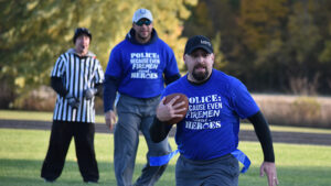 Muncie Police Officer Brandon Qualls runs the ball back during the fire vs. police game at Wapahani High School's flag football game Tuesday night. Photo by: Emma Stanley, Wapahani High School sophomore