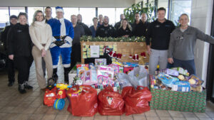 Members of the Muncie Police Department, Greg Hubler Ford Hyundai, and Santa Claus are pictured in front of toys MPD will be delivering to local children. 