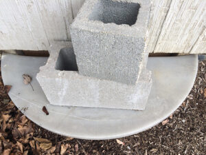 Mere bricks don’t keep critters from finding the crawlspace. Photo by: Nancy Carlson