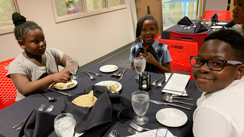 Motivate Our Minds was awarded $20,000 for its 2020-2021 After-School Enrichment Program. A similar grant in 2019 supported Motivate Our Minds. Pictured, students take part in an etiquette dinner as part of the enrichment opportunities provided by Motivate Our Minds.