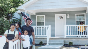 The Lyons family and their new home. Photo by: Amanda Kishel