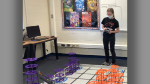 Nicole South is pictured stacking risers during the State Championship on March 6th. Photo provided