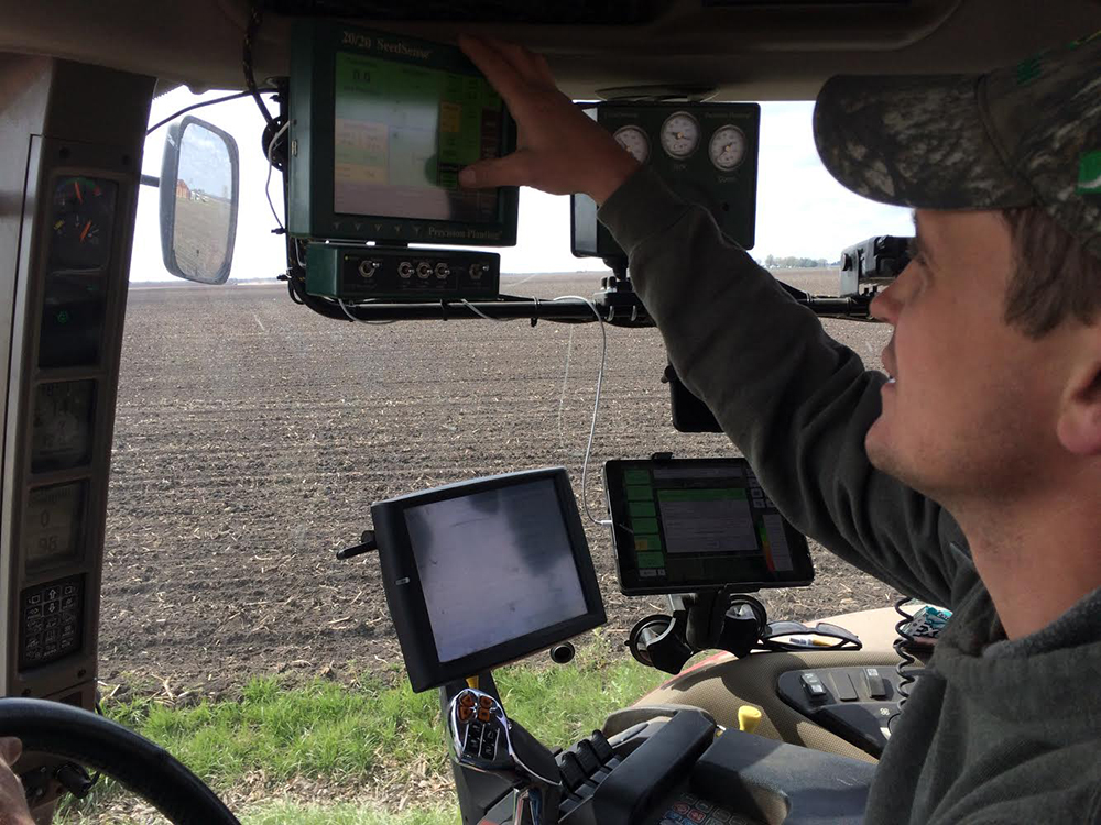 Multiple computer screens help a farmer keep track of his progress. Photo by John Carlson