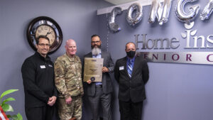 Master Sgt. Steven Leach, 434 ARW command post controller, congratulates his civilian employer Joe Wrin, franchise owner of Home Instead, for earning the Employer Support of the Guard and Reserve Pro Patria award on May 20, 2021 in Muncie, Indiana. Wrin received the award for his extraordinary support of his employees who serve in the Indiana Guard and Reserve.Photo by Mike Rhodes