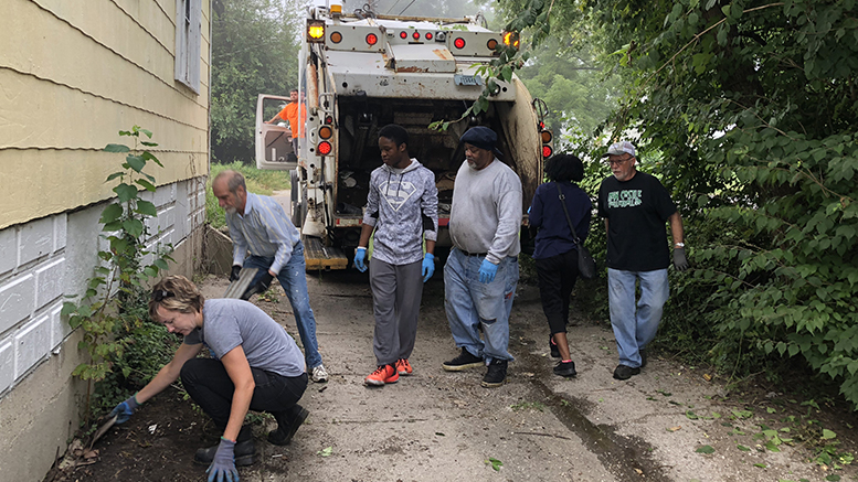 Volunteers work to remove trash and debris from alleys in the McKinley neighborhood. Photo provided