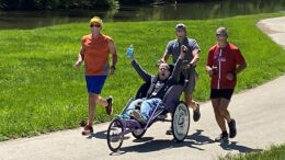 Scott Taylor (L), Lance Ottinger and Paul Stewart push Scott Adams along the White River in a trial run. Photo provided.