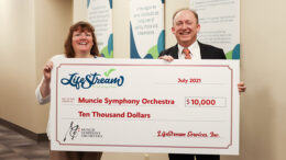 Jenny Hamilton (LifeStream Services) presents a check of $10,000 to Scott Watkins (Muncie Symphony Orchestra).