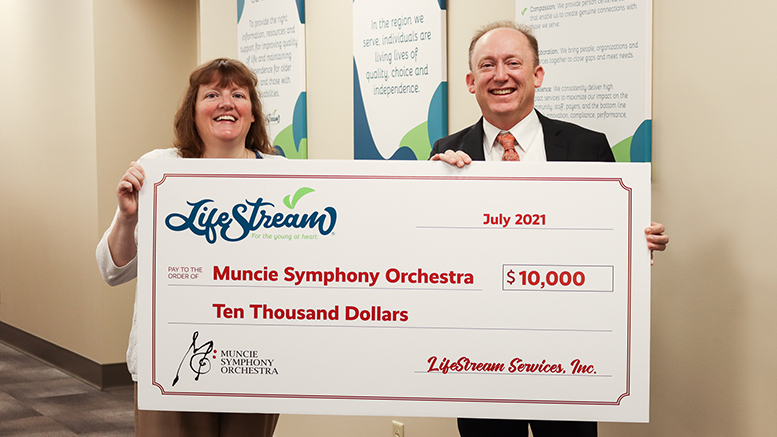 Jenny Hamilton (LifeStream Services) presents a check of $10,000 to Scott Watkins (Muncie Symphony Orchestra).