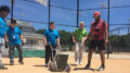 Scott Smalstig (green shirt) guides TeenWorks kids on the fine art of operating a line marker device on a ball field. Photo provided