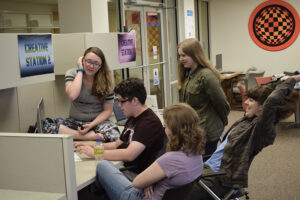 tudents in a previous Summer Film School are shown with camera equipment and working together to edit a video. Photo by Noelle Sherrell, MPL