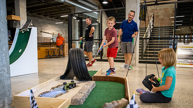 A family enjoys playing micro golf. Photo provided by Accutech