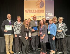 Community members from Delaware County were present to receive the Indiana Healthy Community redesignation certificate and to support John Disher, the Community Wellness Champion award recipient. Photo provided by Indiana Chamber