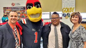 Pictured L-R: Eric Grim - MCS Director of Secondary Education Charlie Cardinal - Ball State mascot Isaac Denniston Dr. Lee Ann Kwiatkowski - MCS Dir. Of Public Education and CEO