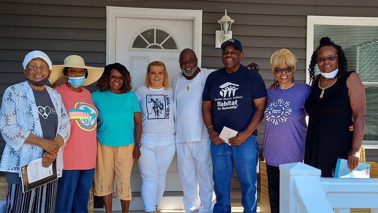 Greater Muncie Habitat for Humanity's 2022 homeowner Charles joined by his brothers and sisters on his front porch. Photo provided by Muncie Habitat for Humanity.