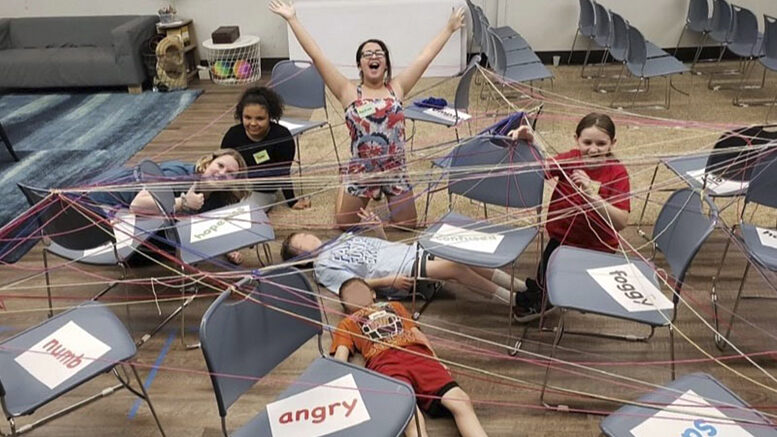 Former SHIFT participants pose in the "web of emotions," an interactive activity to explore complicated emotions around grief. Photo provided