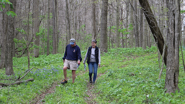 A couple is pictured enjoying the trail at Red-tail’s 2022 Wildflower Celebration. Photo by Elizabeth Ploog