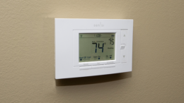 A smart thermostat that can be controlled by a cellular phone is pictured.