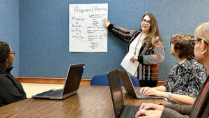 Laura Janiga, MPL employee, reviews the Grant Writing Learning Circle agenda with other MPL employees. Photo by Spenser Querry, MPL Webmaster and Social Media Specialist.