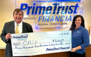 PrimeTrust President Tim Pierce presents a check to CASA's Ashley Soldaat. Photo provided