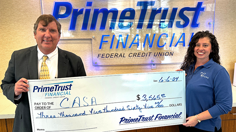 PrimeTrust President Tim Pierce presents a check to CASA's Ashley Soldaat. Photo provided