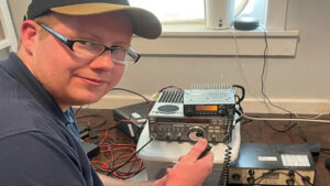 Campbell Reed, President of the Muncie Area Amatuer Radio club is pictured sitting in front of amateur radio equipment. Photo provided