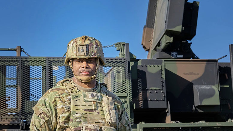 U.S. Army Command Sgt. Maj. Robinson, the Command Sgt. Maj. of 52d Air Defense Artillery Brigade, poses in front of a Sentinel Radar during Exercise Southern Shield in Romania, Nov. 15, 2024. The event highlights NATO's defensive readiness and air defense interoperability among Allied forces. U.S. Army photo by Capt. Leara Shumate.