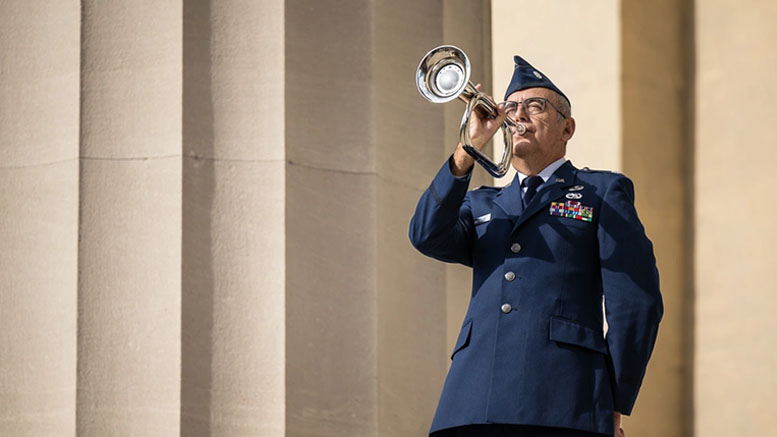 U.S. Air Force Lt. Col Mitch DeLaRosa, retired, plays Taps to close out the annual Veterans Day Parade and Massing of the Colors in downtown Louisville, Ky., on Nov. 9. 2024. The event featured appearances by more than 50 organizations, including the Kentucky Air National Guard and its Mini C-130 Hercules scale replica. U.S. Air National Guard photo by Dale Greer