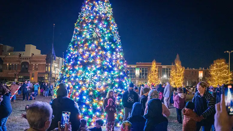 Families gather around the animated, musical holiday tree at Light Up DWNTWN in Canan Commons. Photo provided.