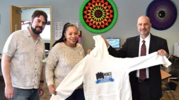 MPL Connection Corner employees Stuart Cotton and Tenisha Harris work with MPL Director Alan Kornblau to imprint a sweatshirt with the 150th Anniversary logo. Photo by Sean Bowdell, Connection Corner Employee.