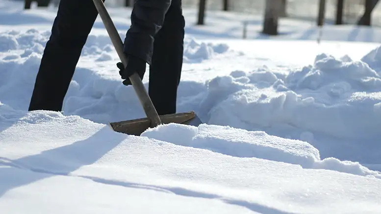 If it does snow this weekend, it is important to not overdo shoveling it. Photo by Storyblocks.