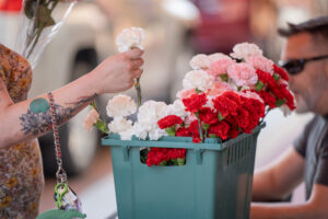 An attendee selects a flower for their bouquet during the 2024 Brink of Summer ArtsWalk Flower Hour. Photo provided.