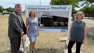 Pictured L-R: Tim Pierce, Lorraine Tomlin and Niccole Mansker stand by an artist rendering of the planned new branch. Photo provided.