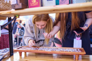 A Fire Up DWNTWN attendee explores merchandise.