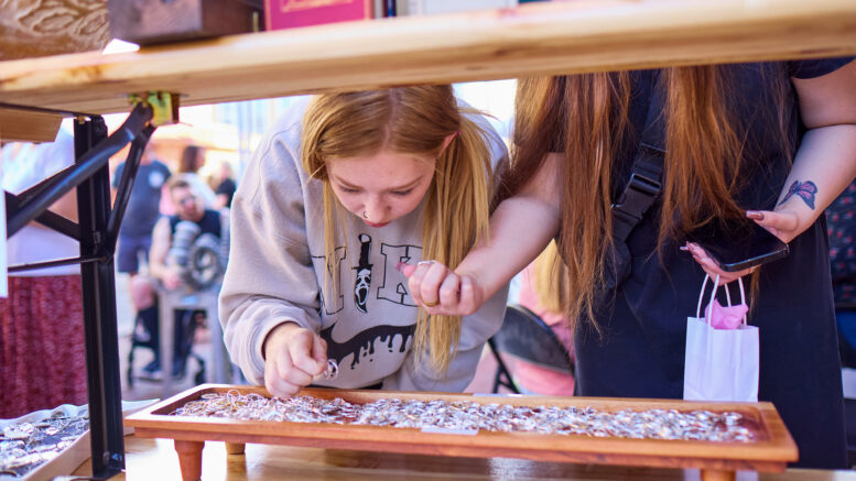 A Fire Up DWNTWN attendee explores merchandise.