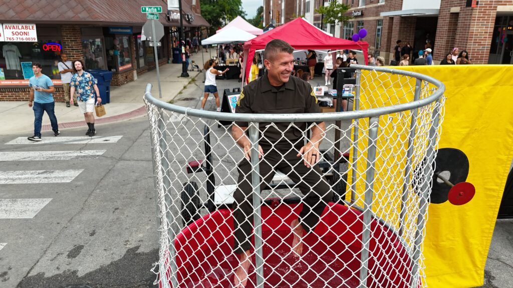Deputy Chief, Delaware County Sheriff, raising money for the Boys and Girls Club in the dunk tank at the $2 Tour of the Village. Photo by Indiana Army National Guard.