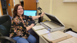 Sara McKinley, Carnegie Library Manager & MPL Archivist, demonstrates the current method of digitalizing historic documents. McKinley will purchase upgraded equipment using the recent Carnegie Corporation grant. Photo by Kailey Armstrong, PR Volunteer Muncie Public Library.